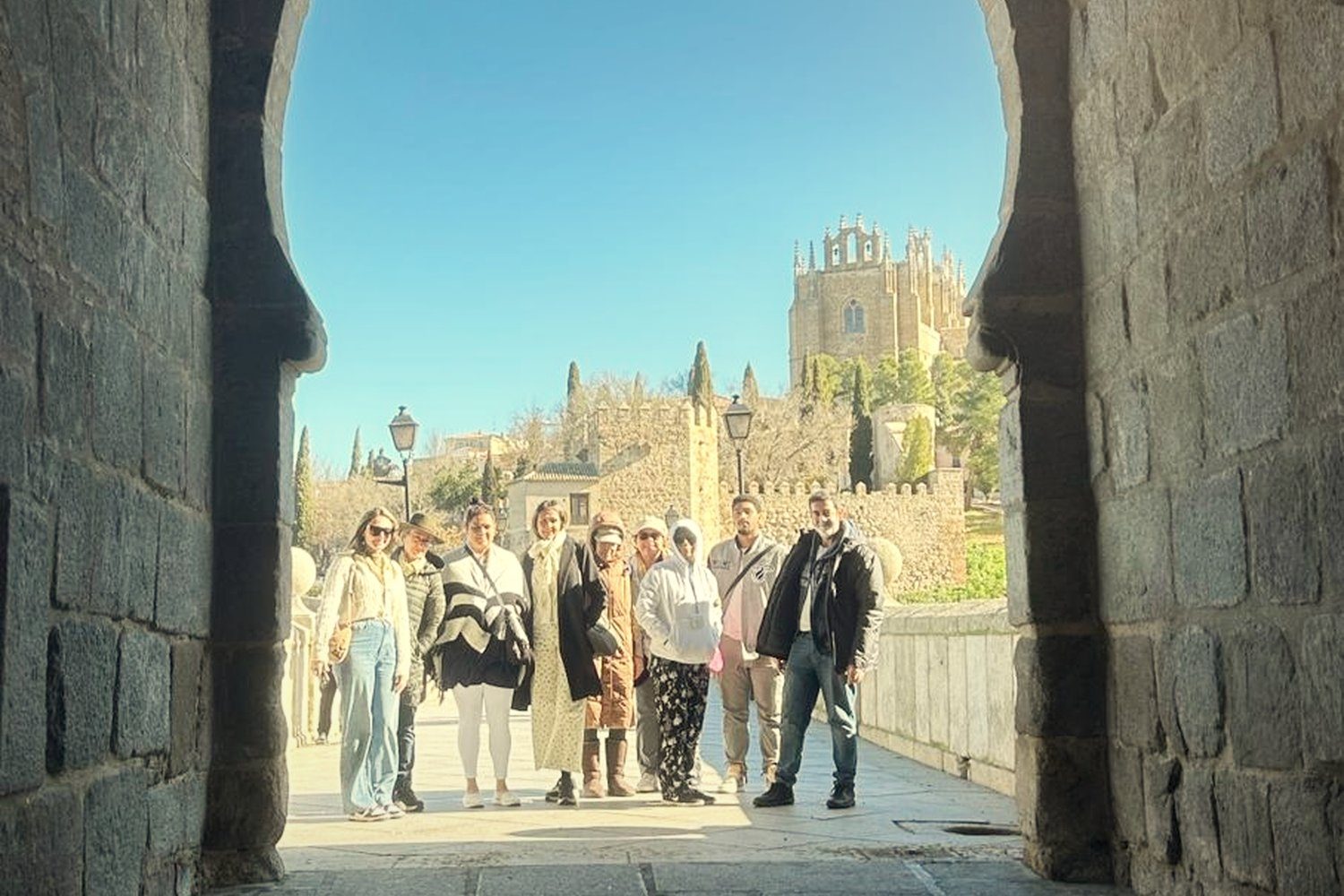 A group framed by a horseshoe arch in Toledo
