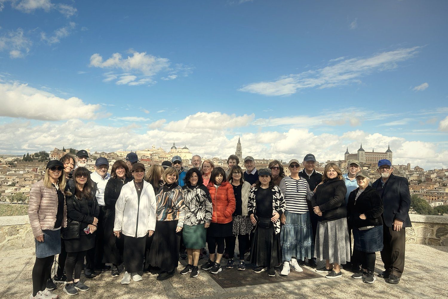 A large group in front of the Toledo skyline