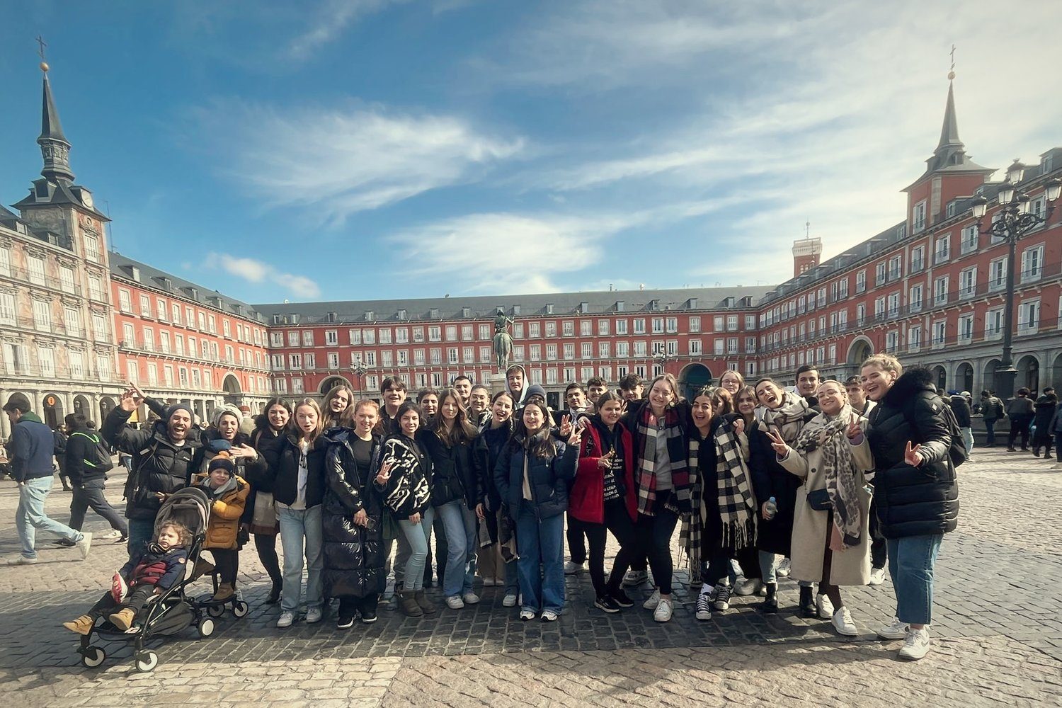 A cheerful group of young travellers in Plaza Mayor