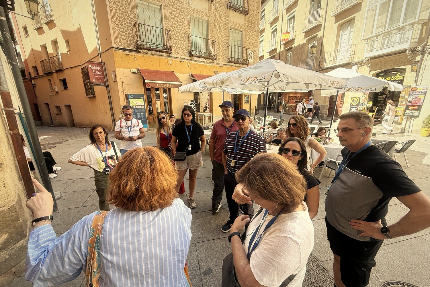 A group listening to a guide in the Jewish quarter of Segovia