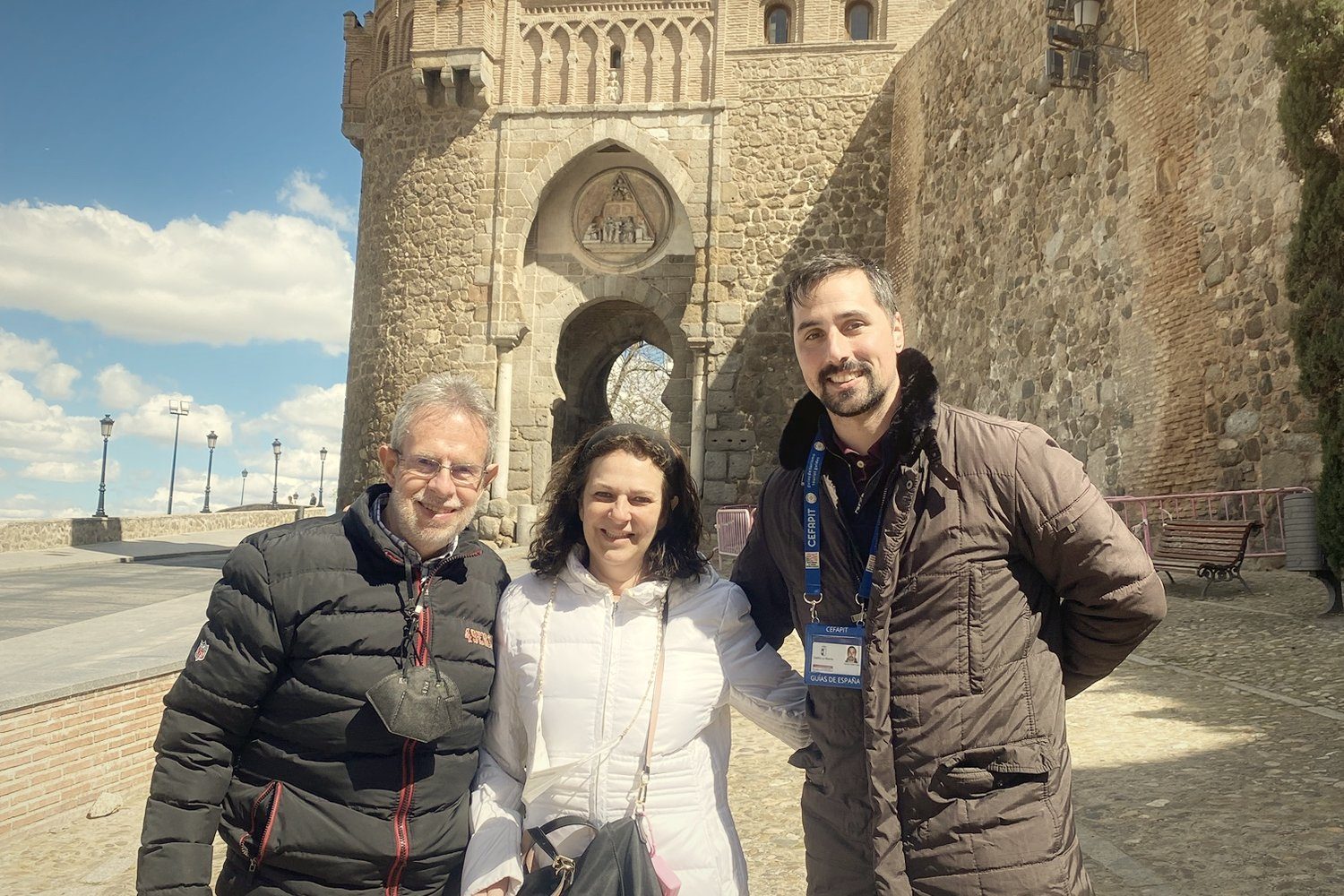 A couple with their guide at the Puerta del Sol gate in Toledo