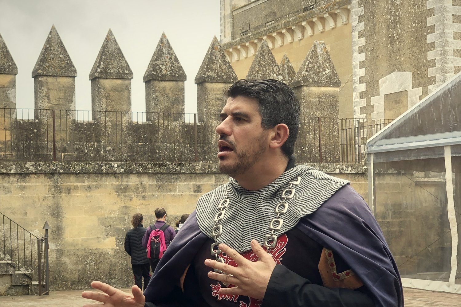 A guide in medieval costume telling stories at the castle