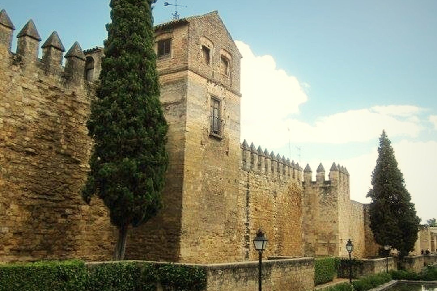 The medieval walls of Córdoba with cypresses and pools