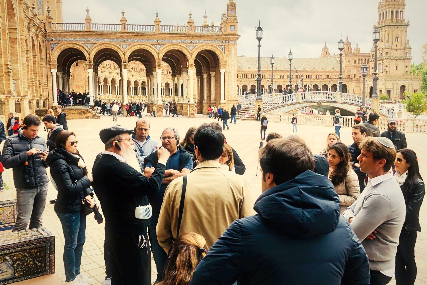 A group listening to a rabbi in Plaza de España, Seville