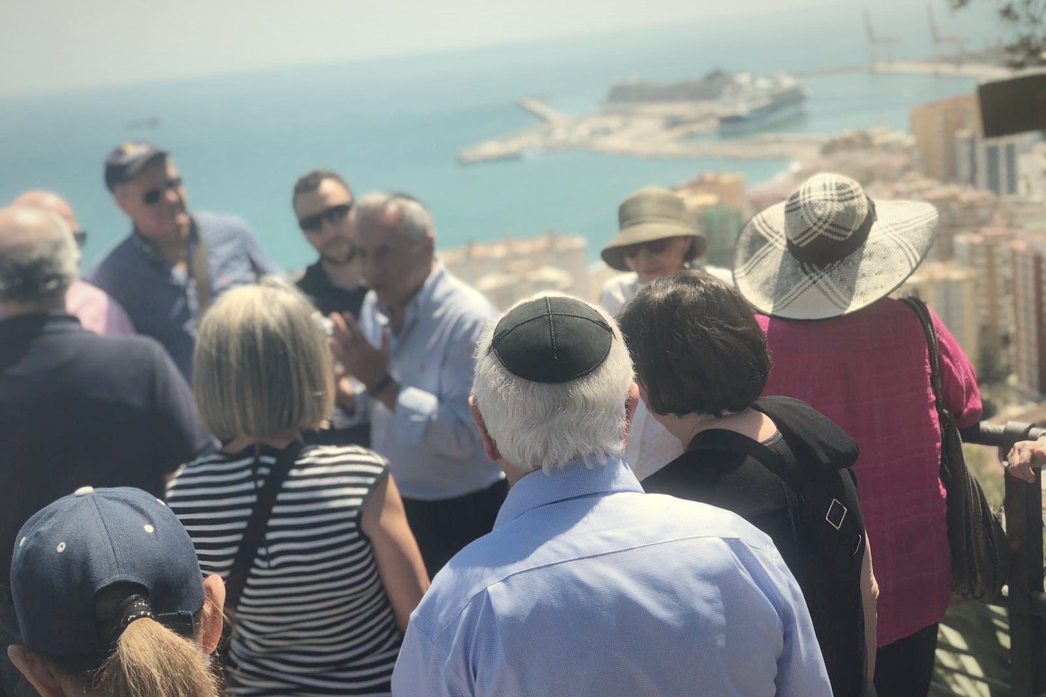 A group at a viewpoint high above the port of Málaga