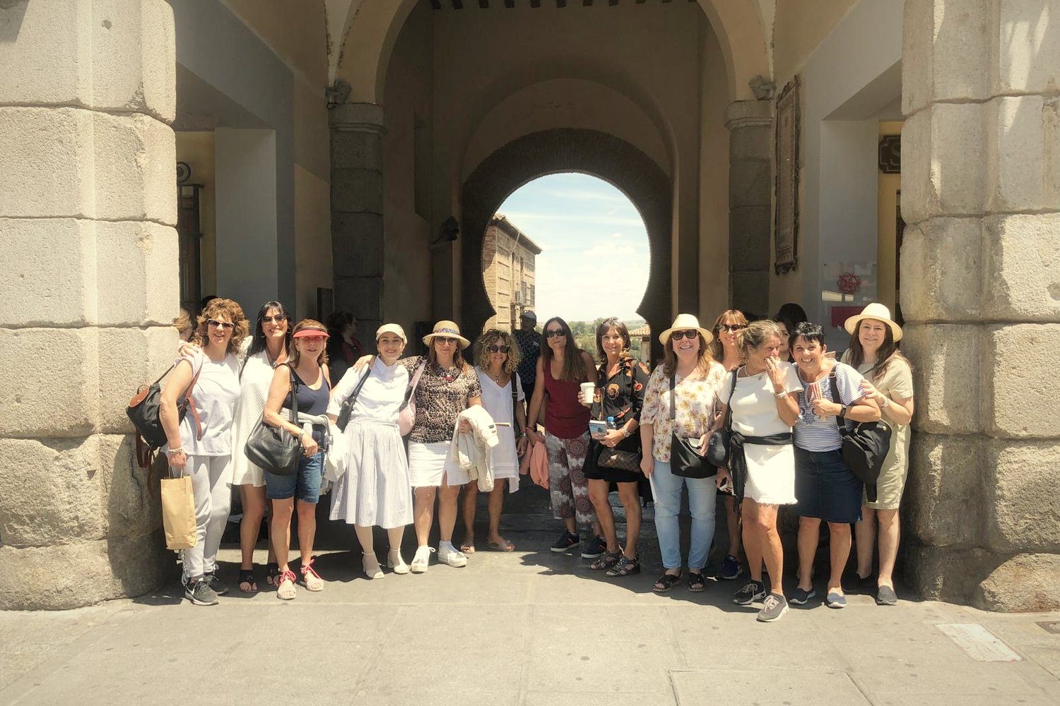 A group of women under a horseshoe arch in Toledo